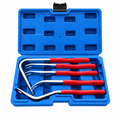 Five red-handled trim and clip removal tools in an open blue carrying case on a pure white background